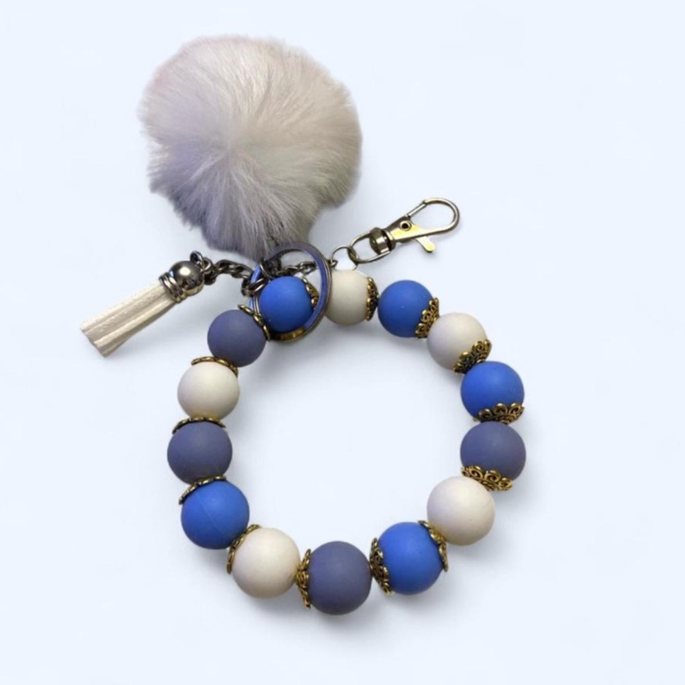 Blue and white bracelet keychain with white pom-pom